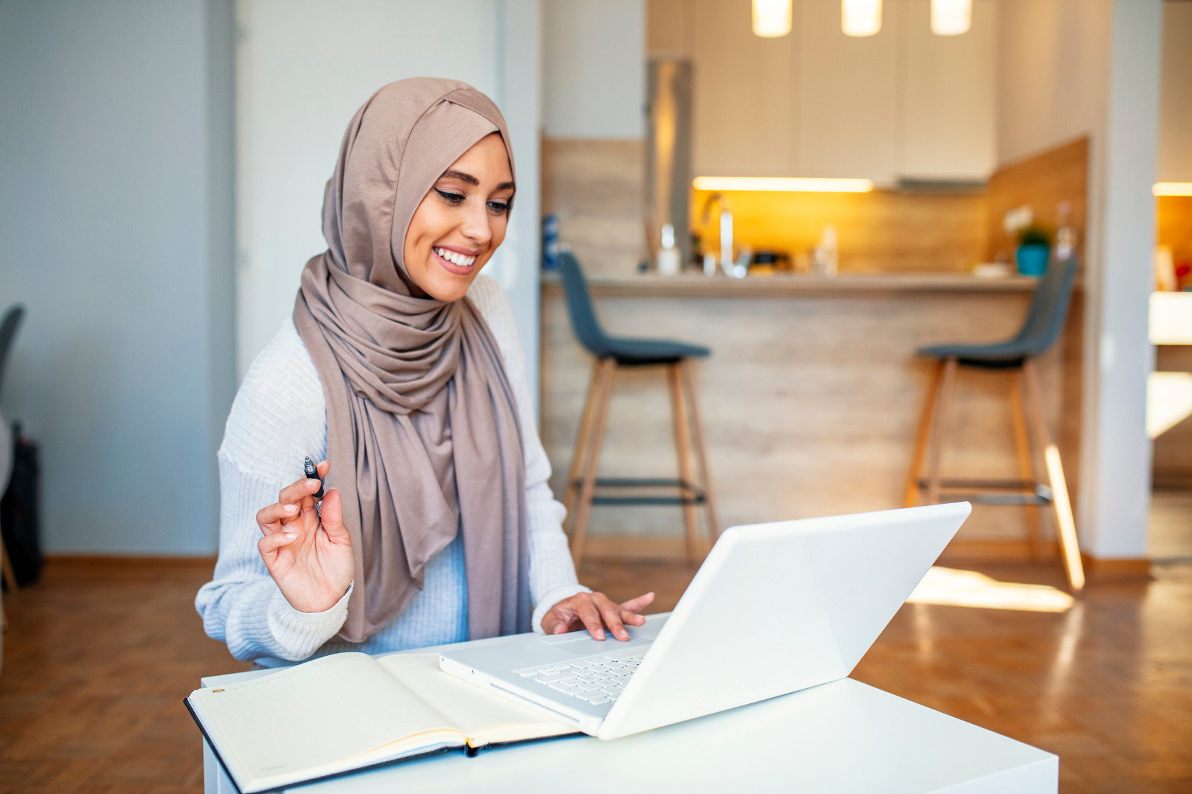 Young Muslim woman using laptop